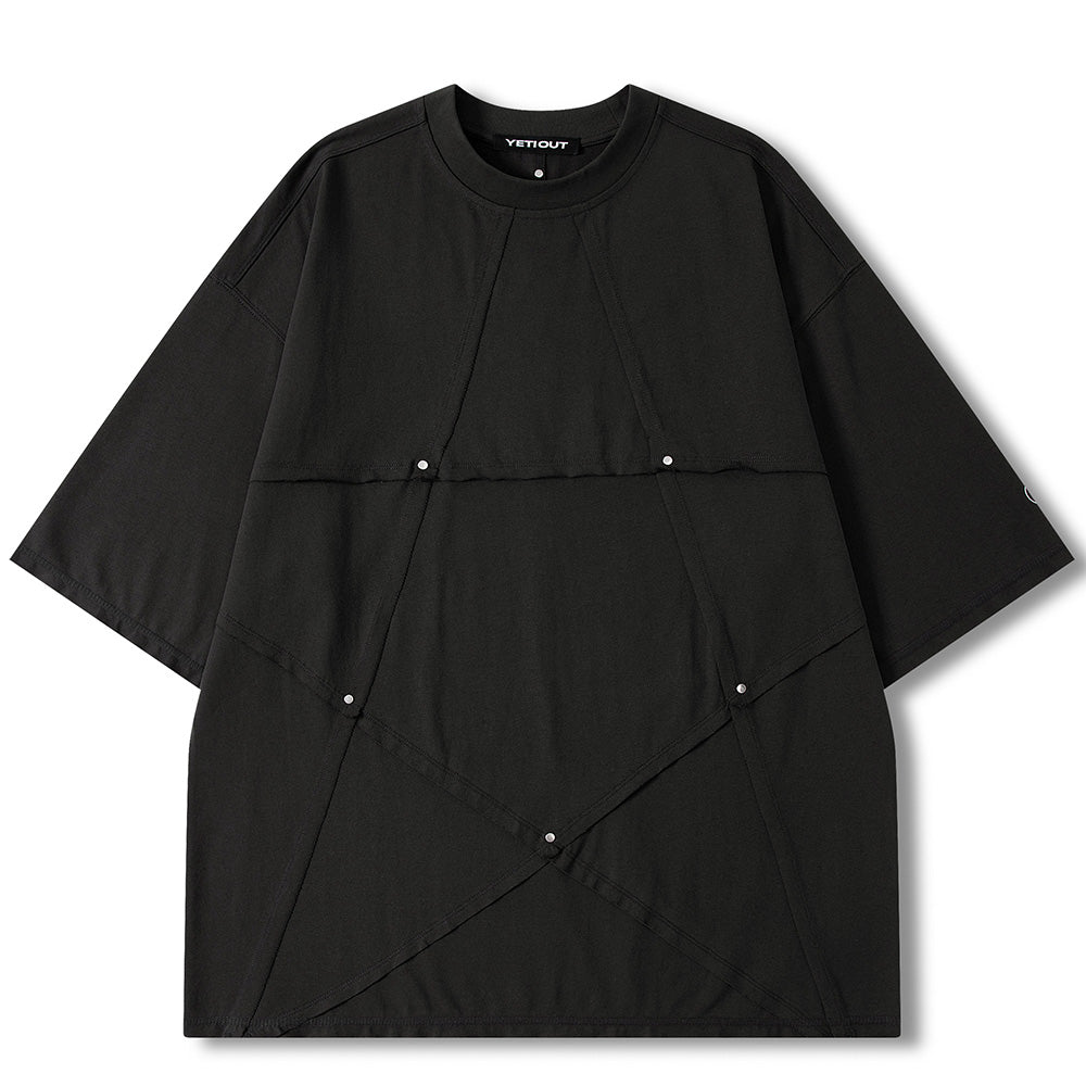A black oversized short-sleeve t-shirt with diagonal seam details and small silver snap buttons, shown flat on a white background. The brand name 'VENDOUT' is visible on the inner neck label.