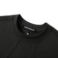 Close-up of a black crewneck sweatshirt showing the ribbed collar with a black YETIOUT brand label.