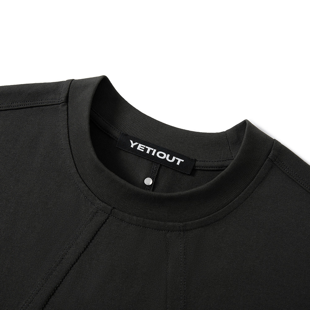 Close-up of a black crewneck sweatshirt showing the ribbed collar with a black YETIOUT brand label.