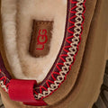 Close-up of UGG logo on a product with red and brown details