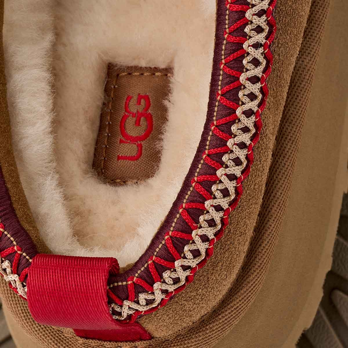 Close-up of UGG logo on a product with red and brown details